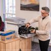 Man replacing toner cartridge in Brother MFC-L8970CDW color laser all-in-one printer