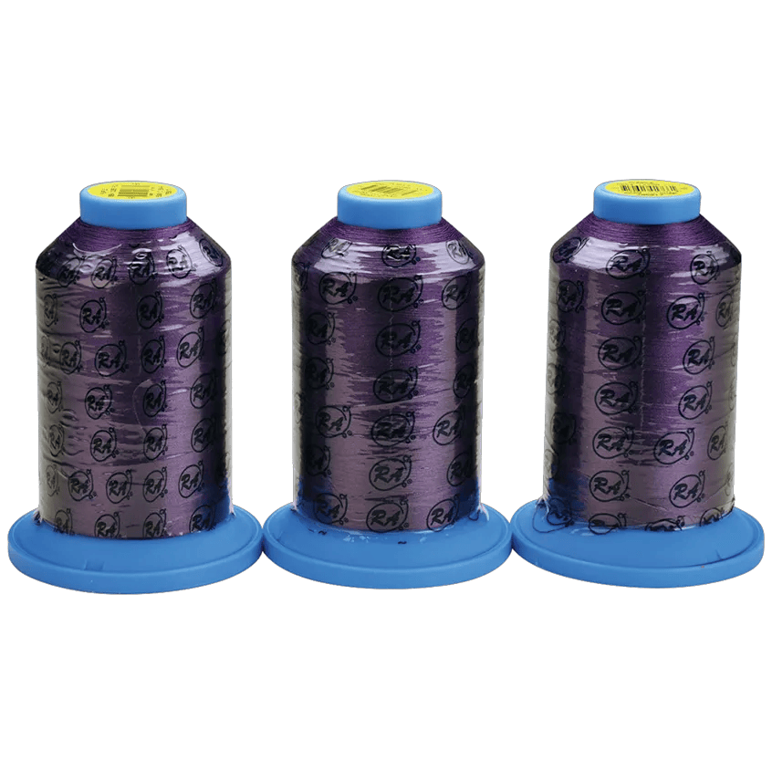 Three purple embroidery thread spools with blue caps displaying Brother logo