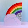 Colorful rainbow with clouds craft decoration on light blue background