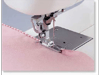Brother sewing machine presser foot stitching pink fabric with decorative edge