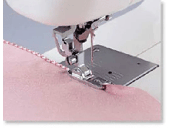 Brother sewing machine presser foot stitching pink fabric with decorative edge