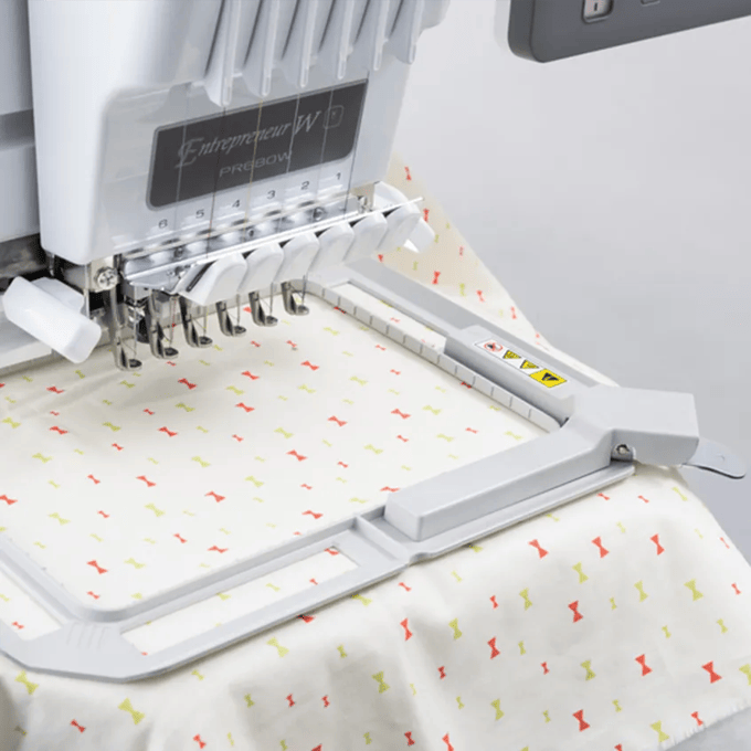 Brother embroidery machine with multi-needle system stitching patterned fabric in hoop