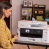 Woman using Brother MFC-J5340DW all-in-one wireless inkjet printer in home office