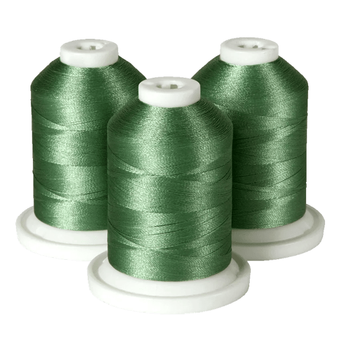 Three green embroidery thread spools on white bases