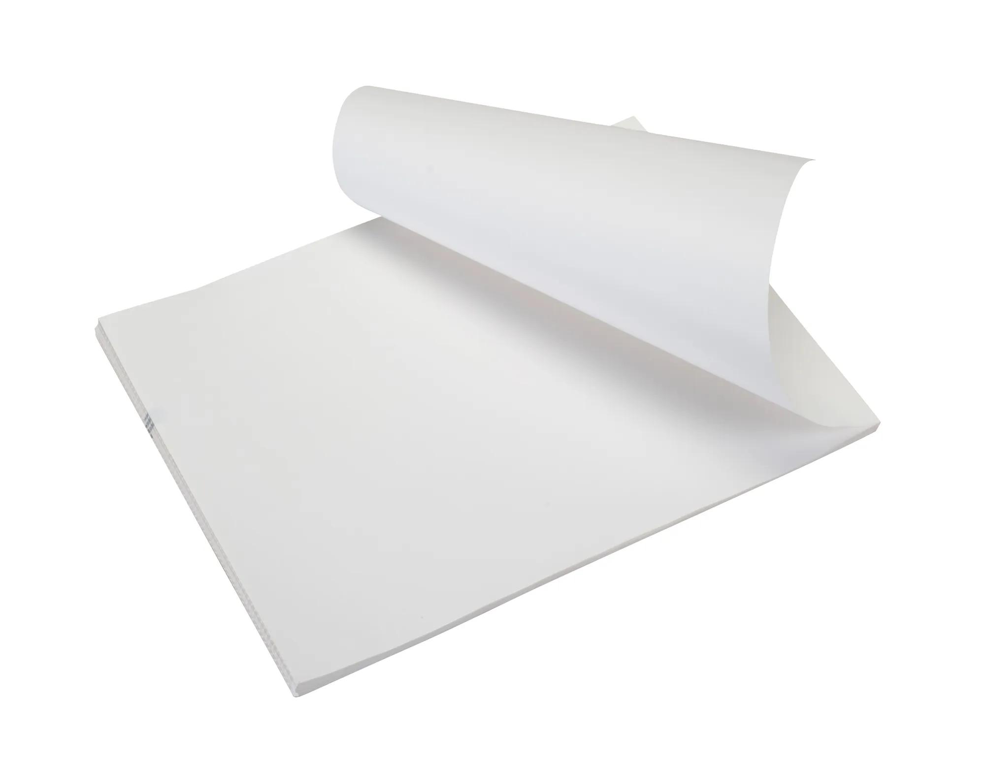 Stack of white letter-size paper with top sheet curled, showing smooth texture