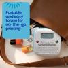 Brother P-touch portable label maker in open brown bag with nail polish and accessories