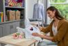 Woman embroidering with Brother SE2100D sewing and embroidery machine in home craft room
