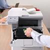 Person replacing toner cartridge in Brother MFC-L5715DW all-in-one laser printer in office