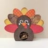 Decorative turkey craft holder with colorful patterned feathers on white surface