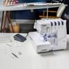 Brother Air1800 serger with foot pedal and accessories in sewing workspace