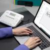 Brother P-touch label maker with laptop displaying design software for office organization
