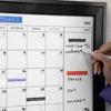 Brother laminated labels on dry-erase calendar organizing meetings and product launches