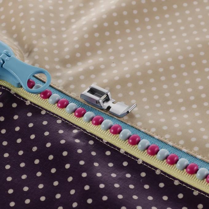 Brother sewing machine presser foot attaching decorative beaded trim to polka dot fabric