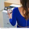 Woman using smartphone to print from Brother HL-L9410CDN color laser printer in office