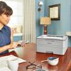 Woman printing from smartphone with Brother wireless laser printer in home office