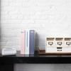 Brother PT-D220 handheld label maker with organized storage drawers and binders on black shelf