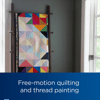 Colorful geometric quilt displayed on wooden ladder showcasing Brother free-motion quilting