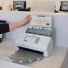 Brother ADS-4700W wireless document scanner with touchscreen scanning vital records in office