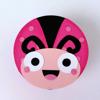 Pink and black ladybug craft made from paper with googly eyes and smiling face
