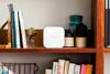 Brother P-touch Cube wireless label maker displayed on wooden shelf in home office setting