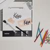 Brother portable scanner with personalized name cards and colored pencils on desk
