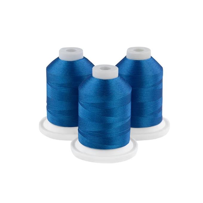 Three spools of Baltic blue embroidery thread on white bases