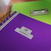 Brother label maker creating custom labels on purple and green notebooks