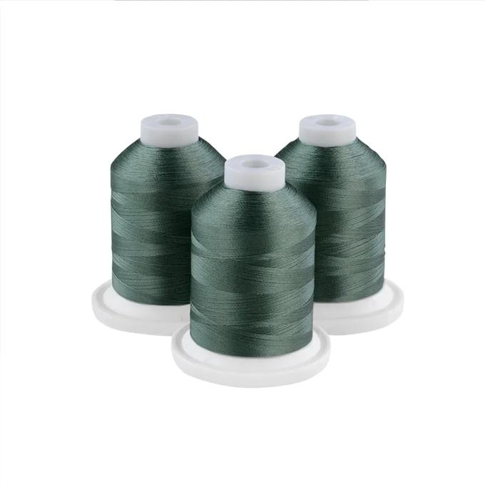 Three willow green embroidery thread spools on white bases