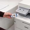 Hand tapping ID badge on Brother MFC-L8395CDW all-in-one color laser printer with NFC