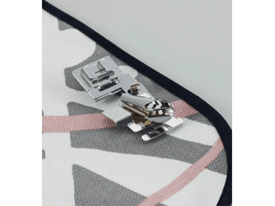 Brother sewing machine presser feet on patterned fabric with zigzag stitching