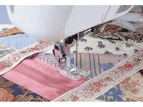 Brother sewing machine stitching decorative zigzag pattern on colorful quilt fabric