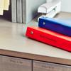 Brother label maker organizing binders on desktop filing system with alphabetical drawers