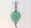Green radish plush toy with smiling face and fabric leaves
