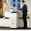 Two professionals sharing documents at Brother MFC-L9610CDN color laser all-in-one printer