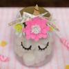 DIY unicorn-themed mason jar decorated with paper flowers, gold ribbon, and unicorn horn