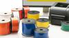 Brother label printer with colorful label rolls on desk for organizing and identification