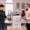 Brother all-in-one color laser printer with optional paper trays in modern office setting