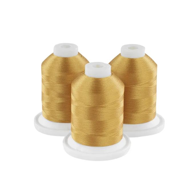 Three gold embroidery thread spools on white bases