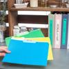 Brother label maker organizing colorful file folders on home office shelf