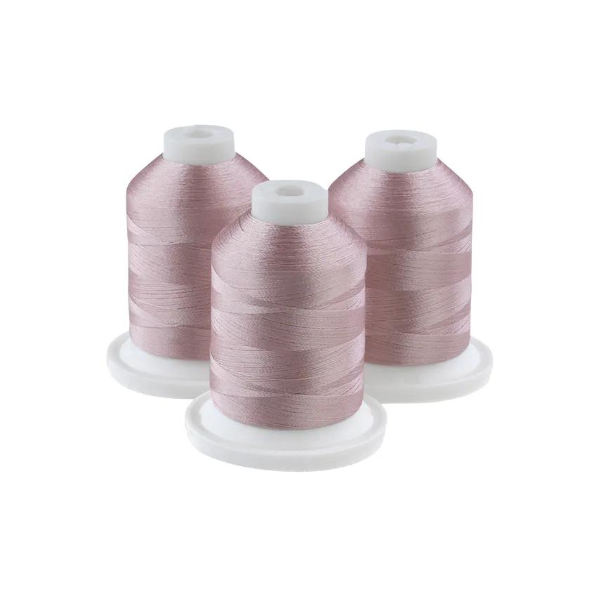 Brother embroidery thread spools in ecru pink on white cones
