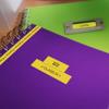 Brother label maker creating custom labels on purple and green notebooks