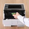 Hand replacing toner cartridge in Brother HL-L6217DW monochrome laser printer