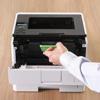 Hand replacing toner cartridge in Brother HL-L6210DW monochrome laser printer