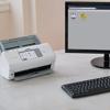 Brother ADS-4700W wireless document scanner with touchscreen on office desk
