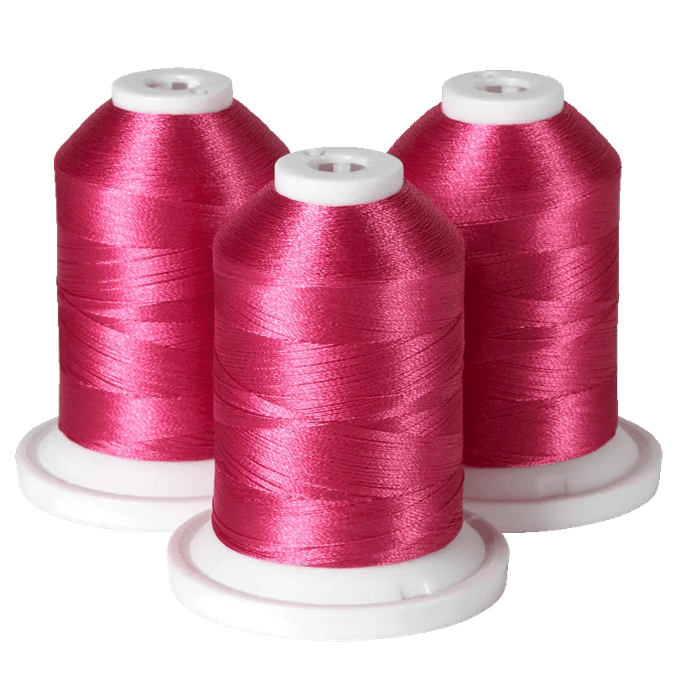 Three spools of pink embroidery thread on white bases for Brother sewing machines