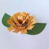 Yellow paper flower craft with green leaves on white background