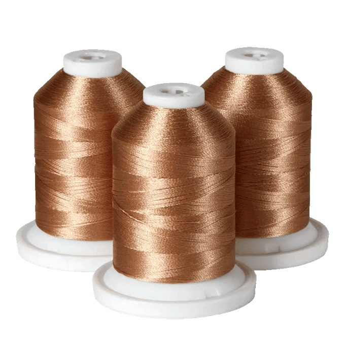 Three spools of copper-colored embroidery thread on white bases