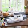 Brother embroidery machine with touchscreen and character design on fabric in home workspace