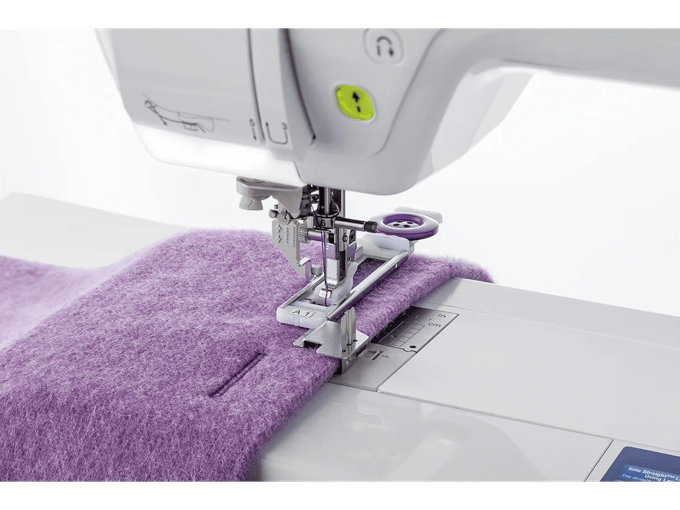 Brother sewing machine stitching purple fabric with automatic needle threader