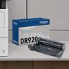 Brother DR920 drum unit with packaging next to laser printer